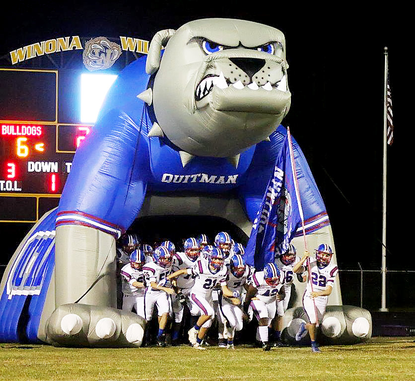 The Quitman Bulldogs run through their new Bulldog tunnel which made its debut Friday at Winona. The big Bulldog was made possible through local donations. (Photo by Sheree Phillips)